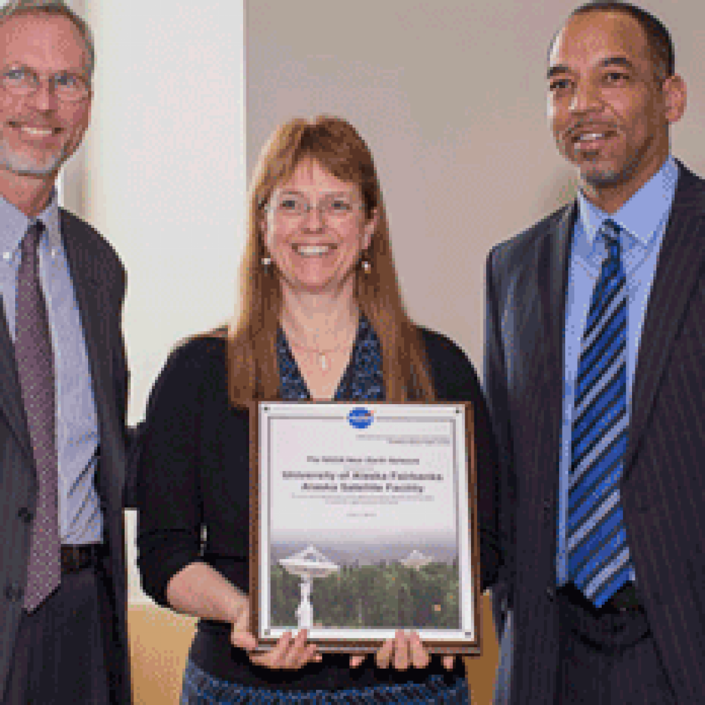 Flanked by UAF President Jim Johnsen (left) and NASA NEN project manager David Carter (right), ASF Director Nettie La Belle-Hamer displays a plaque presented to ASF by Carter.