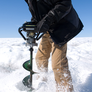 Joughin drilling a hole for installing a seismometer near a supra glacial lake in Greenland. Credit; Chris Linder